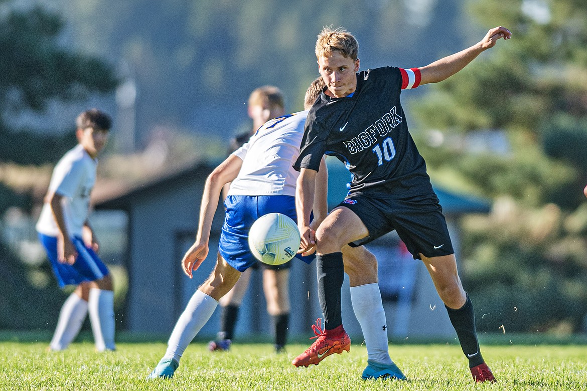 Pawl Bryman snags the ball from Libby on Thursday. (Avery Howe/Bigfork Eagle)