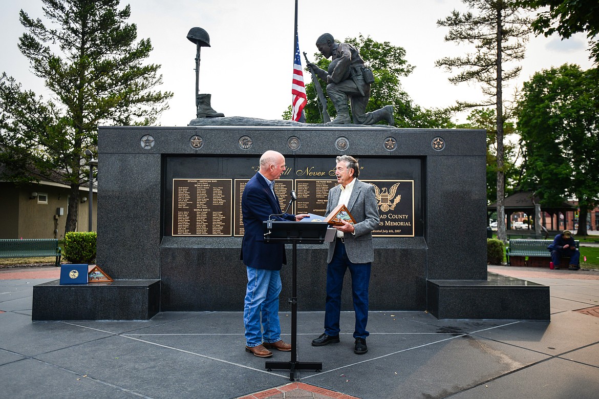 Gov. Greg Gianforte awards Wayne Sand with the 2023 Montana Governor’s Veteran Commendation during a 9/11 Remembrance Day ceremony at Depot Park in Kalispell on Wednesday, Sept. 11. The award recognizes outstanding Montana veterans who have selflessly served their country in uniform and made a positive impact in their community. (Casey Kreider/Daily Inter Lake)