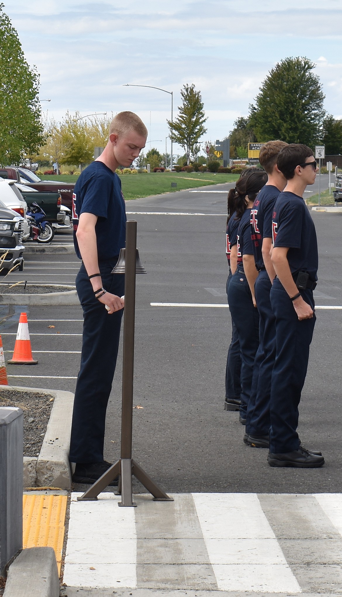 A Columbia Basin Technical Skills Center Fire Science student rings the ceremonial Four Fives in memory of the firefighters who lost their lives on Sept. 11, 2001.