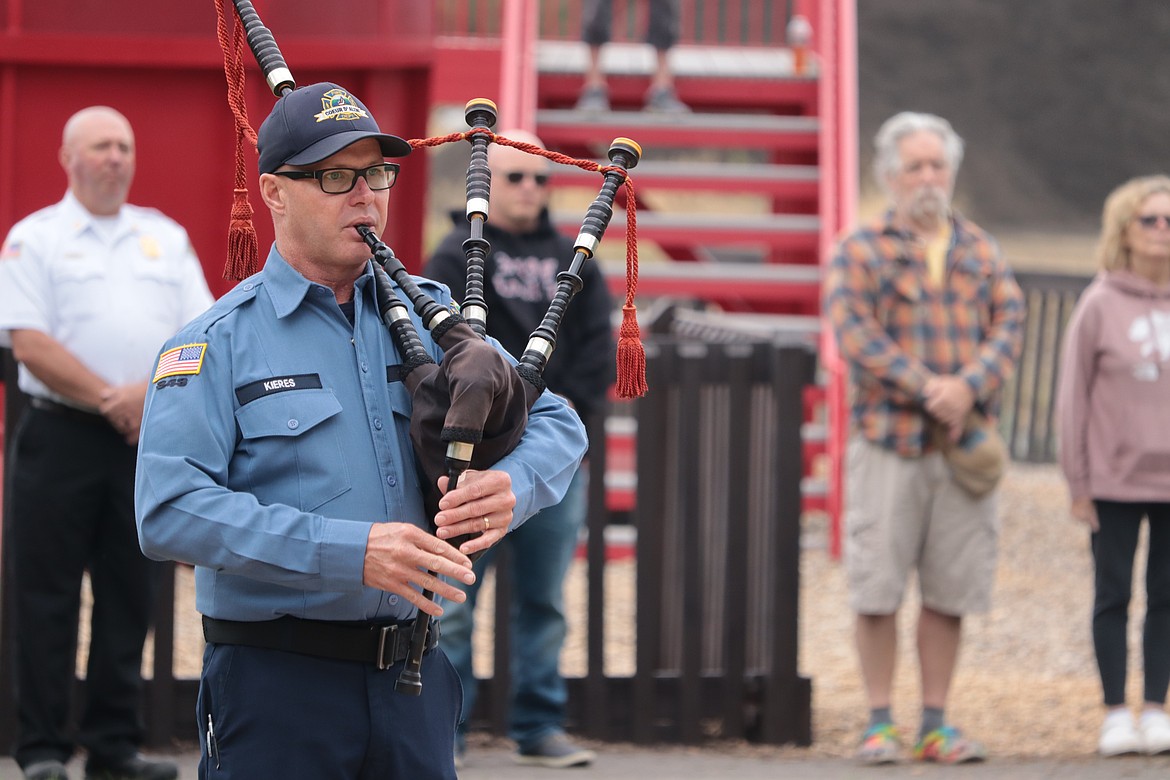 Coeur d'Alene Fire Department Capt. Chris Kieres plays “Amazing Grace" at Fallen Heroes Plaza at Cherry Hill Park on Wednesday.