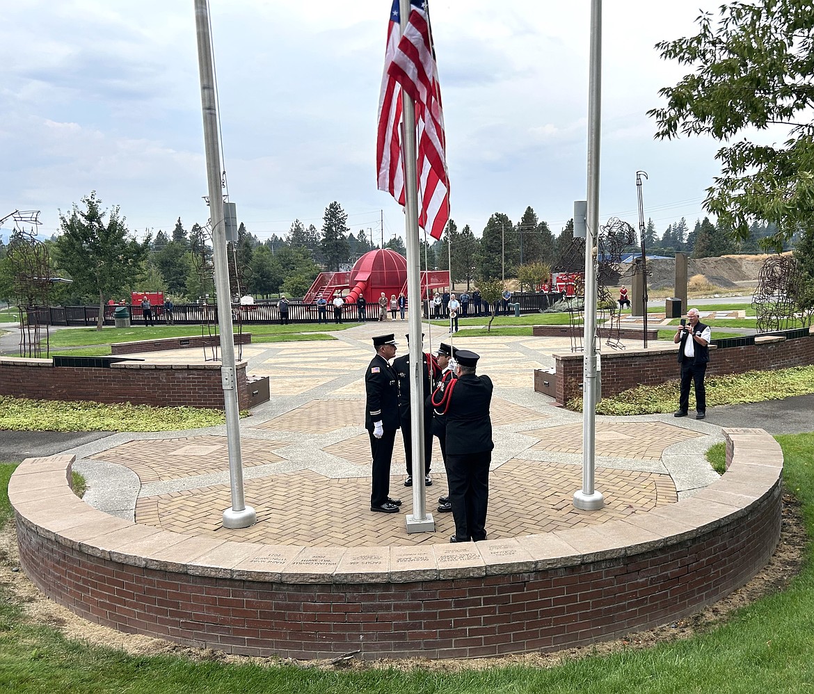 The Coeur d'Alene Firefighters honor guard raises the flag at Fallen Heroes Plaza on Wednesday.