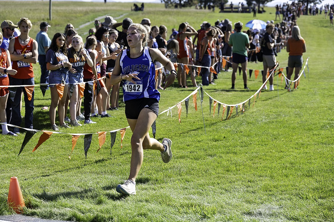 Mya Badger crossing the finish line at the Kalispell cross country meet. Seth Anderson Photo.