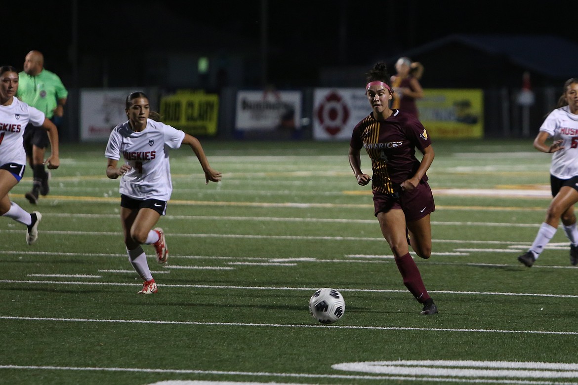 Moses Lake junior Amaya Perez, in maroon, brings the ball up the field against Othello on Tuesday night.