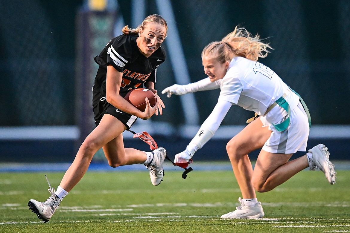 Flathead's Julia Kay (23) is tackled by Glacier's Emma Pate (16) at Legends Stadium on Thursday, Sept. 12. (Casey Kreider/Daily Inter Lake)