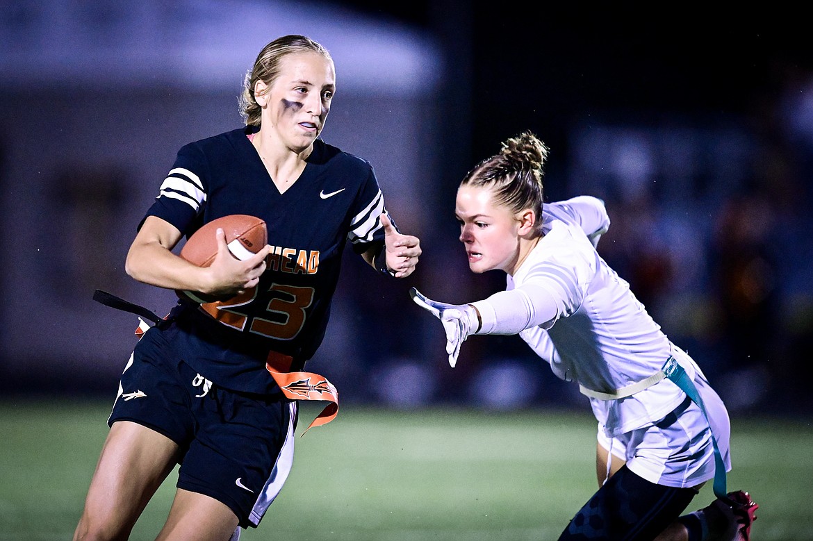 Flathead quarterback Julia Kay (23) tries to get around Glacier's Breanna Barnes (2) at Legends Stadium on Thursday, Sept. 12. (Casey Kreider/Daily Inter Lake)