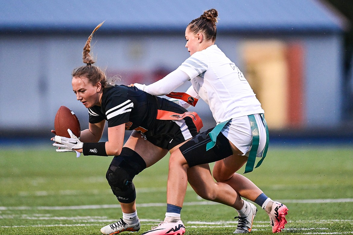 Flathead's Kylie Anderson (9) is tackled by Glacier's Breanna Barnes (2) after a reception at Legends Stadium on Thursday, Sept. 12. (Casey Kreider/Daily Inter Lake)