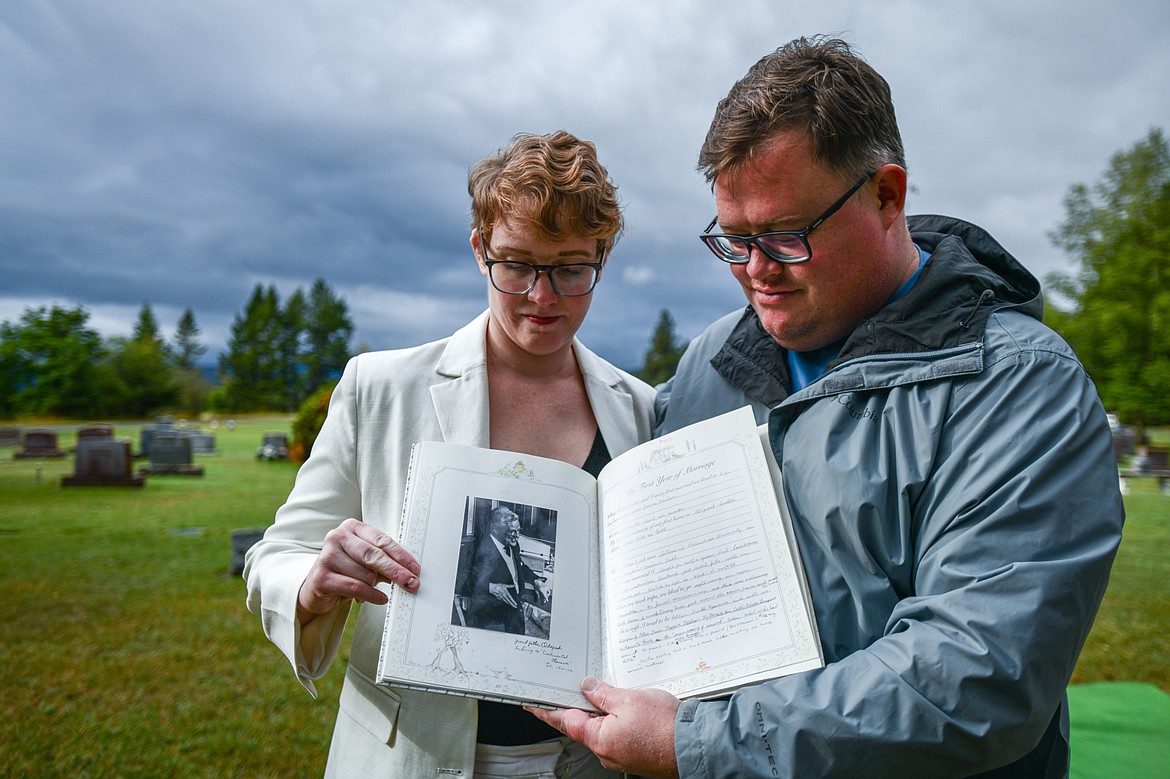 Erika and Ike Odegard hold a picture of their grandfather Peter during an interment of ashes ceremony at C.E. Conrad Memorial Cemetery on Thursday, Sept. 12. (Casey Kreider/Daily Inter Lake)