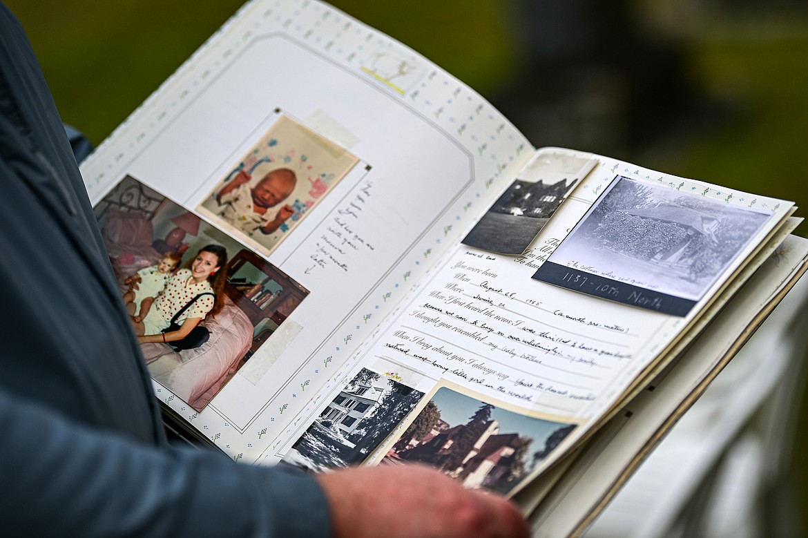 Ike Odegard pages through a family memory book on Thursday, Sept. 12. (Casey Kreider/Daily Inter Lake)