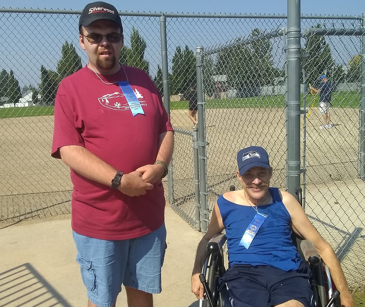 John Painter and Bob Leichtman show off the championship ribbons they earned at the regional bocce ball tournament.