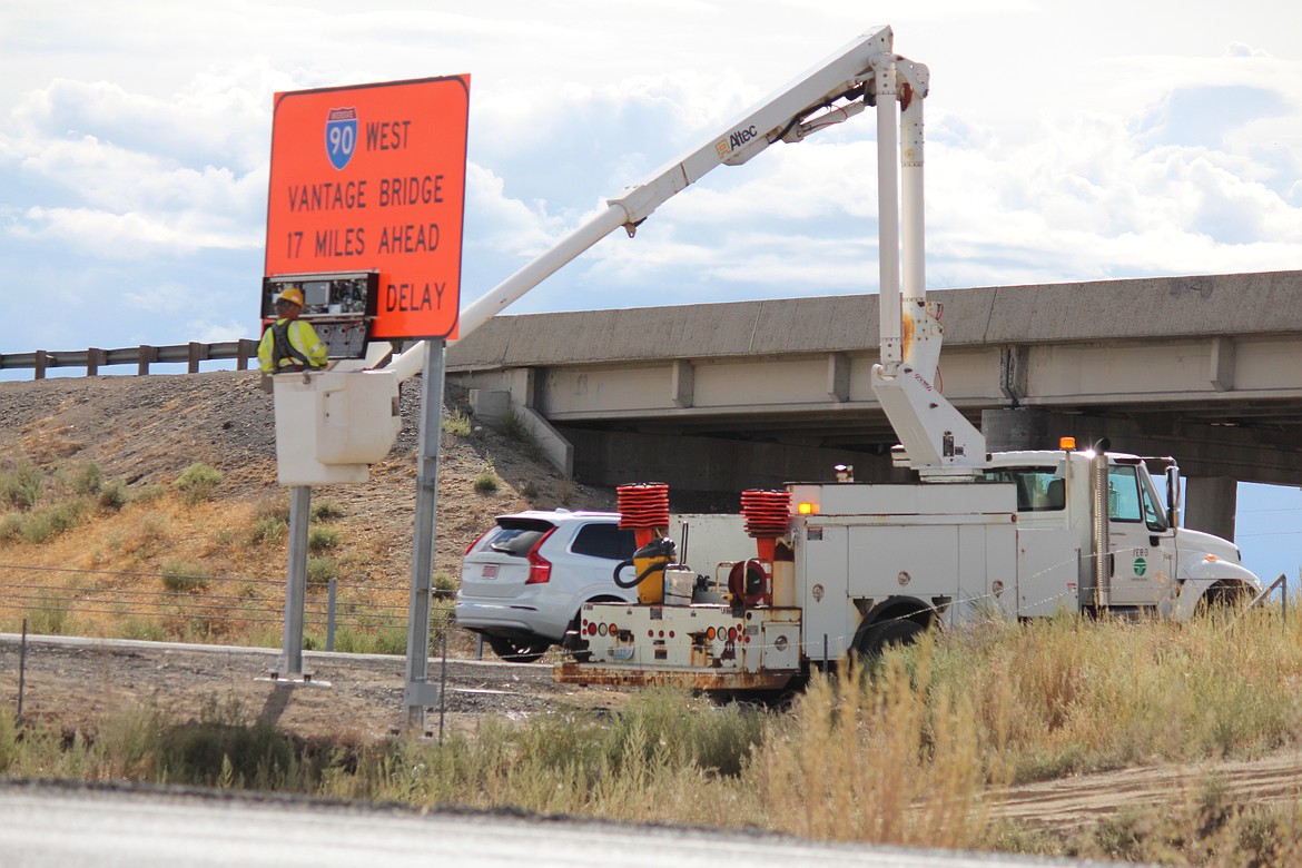 A Washington Department of Transportation worker checks the innards of a sign that updates drivers on possible delays at the Vantage Bridge. Construction has shifted to 24/7 at the bridge, which led to substantial delays last weekend.