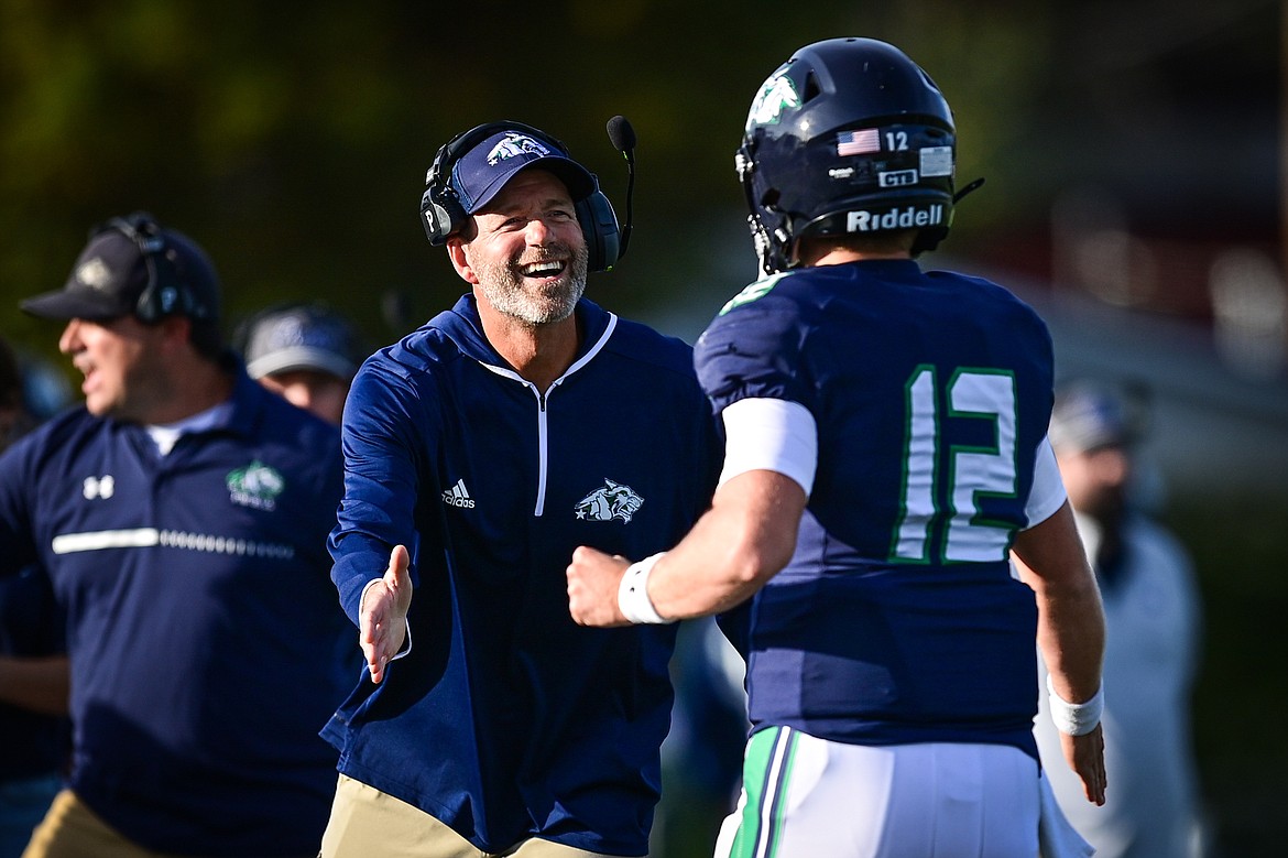 Glacier head coach Grady Bennett congratulates quarterback Jackson Presley (12) after throwing a touchdown pass to wide receiver Ethan Anderson in the first quarter against Butte at Legends Stadium on Friday, Sept. 13. (Casey Kreider/Daily Inter Lake)