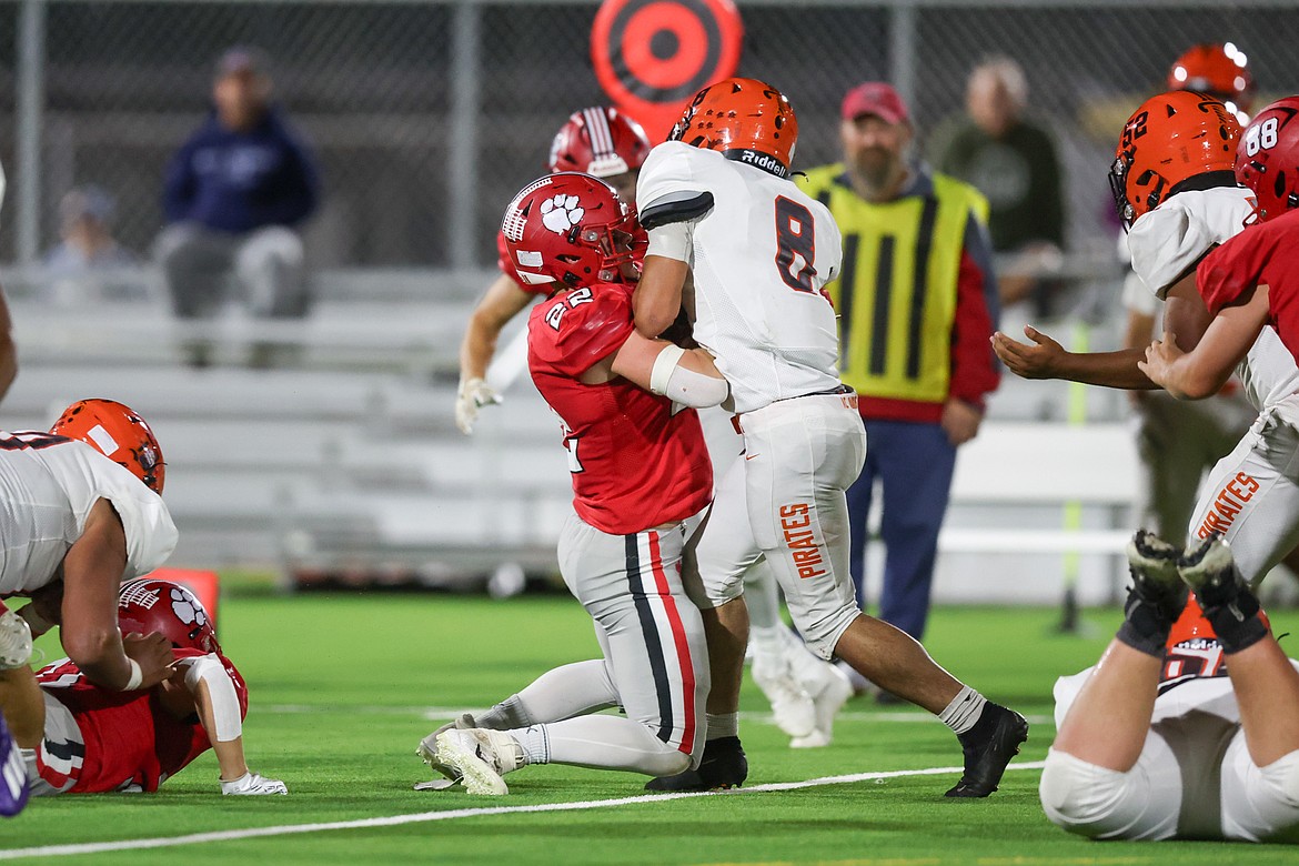 Sandpoint High senior defensive back Wylie Wimmer stops Davis High senior running back Damian Guizar short of the line of gain on a fourth down and short on Friday.