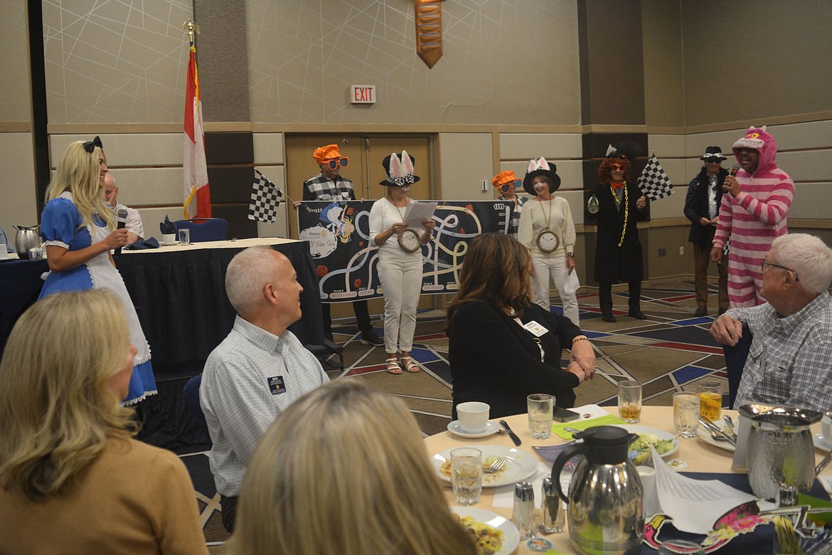 Max Mendez, dressed as the Cheshire Cat, speaks during an "Alice in Wonderland"-inspired Rotary Club skit about the rose sale fundraiser Friday at The Couer d'Alene Resort.