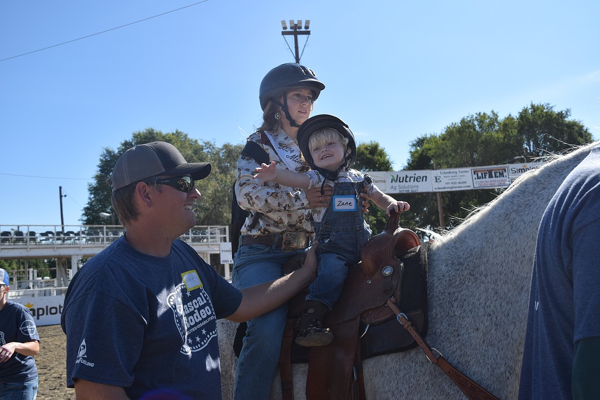 Zane, a participant at the Rascal Rodeo, rode a horse with Miss Othello Rodeo Queen, Milie Cobb, Sept. 13.