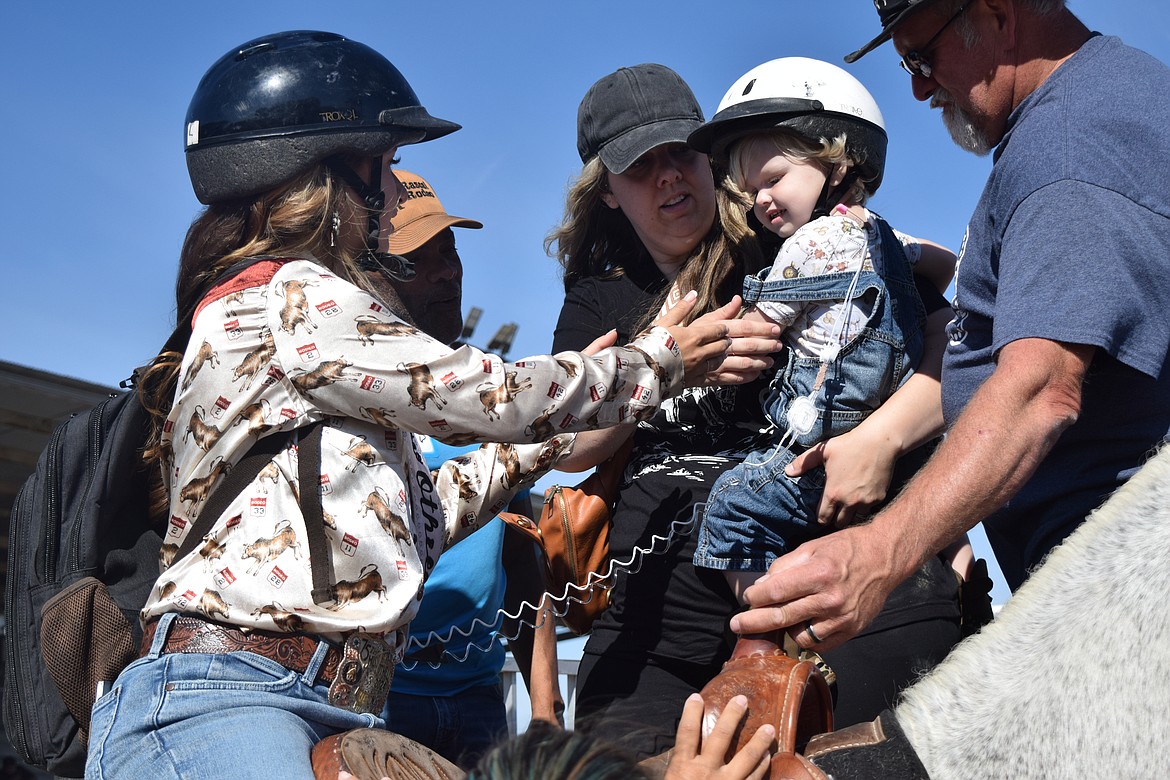 Zane, a participant at the Rascal Rodeo, an all-ages adaptive rodeo for people with disabilities got onto Smokey the horse with Milie Cobb, the Othello Rodeo Queen.