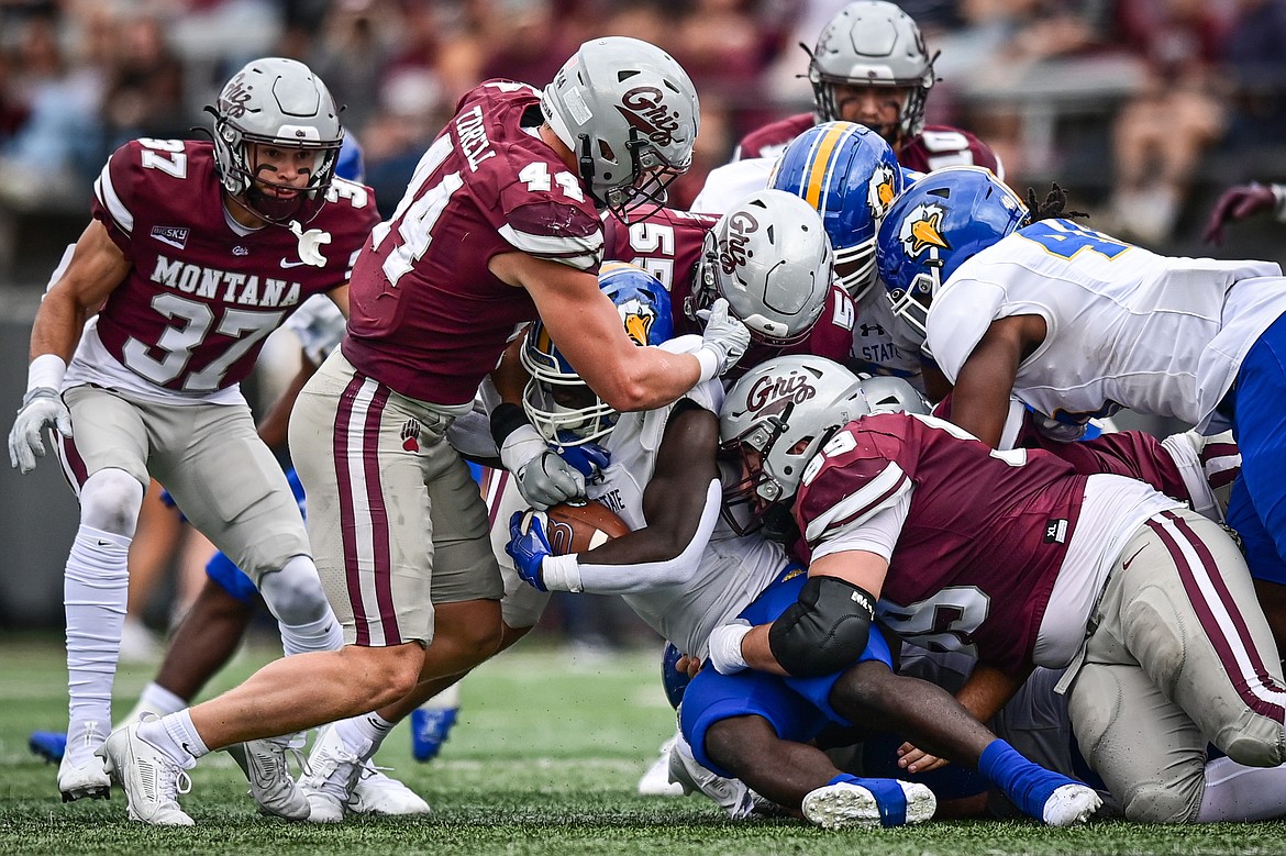 Grizzlies defenders including Ryan Tirrell (44), Andres Lehrmann (55) and Patrick Hayden (99) stop a run in the second quarter against Morehead State on Saturday, Sept. 14. (Casey Kreider/Daily Inter Lake)