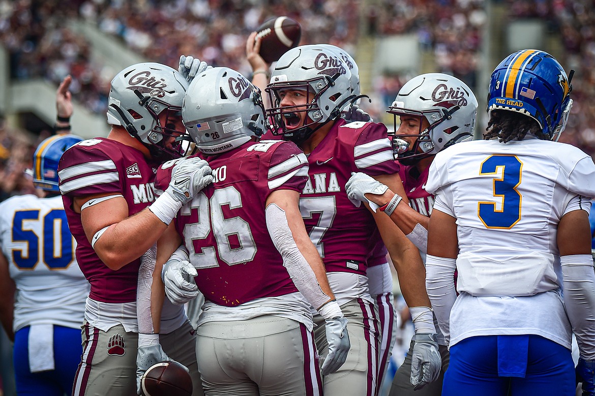 The Grizzlies celebrate after running back Nick Ostmo's (26) 10-yard touchdown run in the second quarter against Morehead State on Saturday, Sept. 14. (Casey Kreider/Daily Inter Lake)