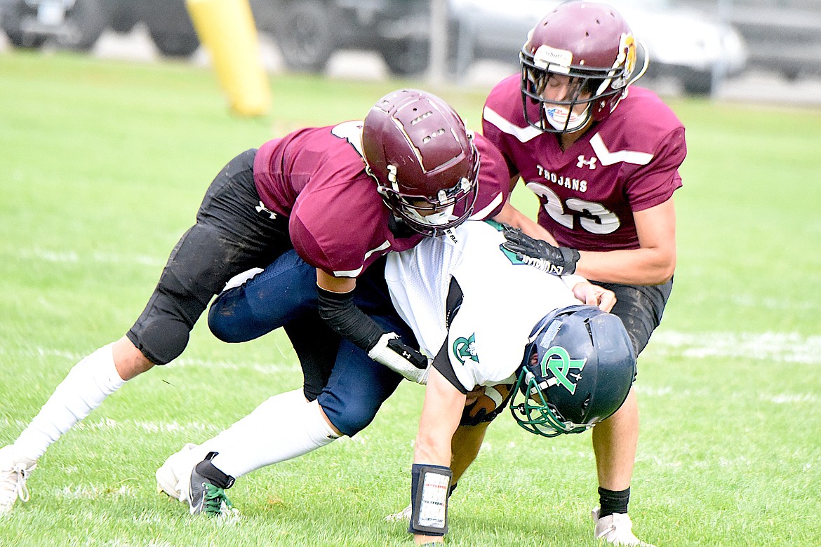 Troy's JJ Hall and Carson Orr bring down ball carrier Saturday, Sept. 14, 2024, against Valley Christian. (Scott Shindledecker/The Western News)