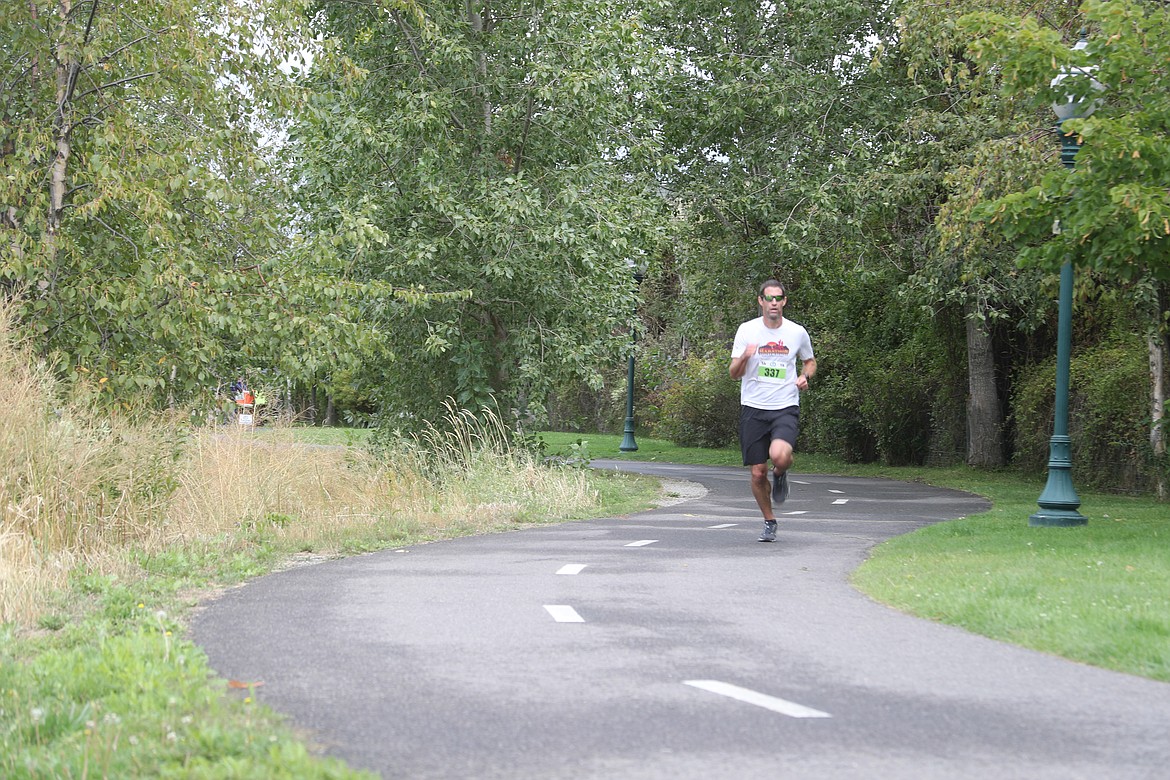 Clay Demastus runs along the Sand Creek Trail during the 5K race of Bonner General Health's Family Fun Run on Saturday.