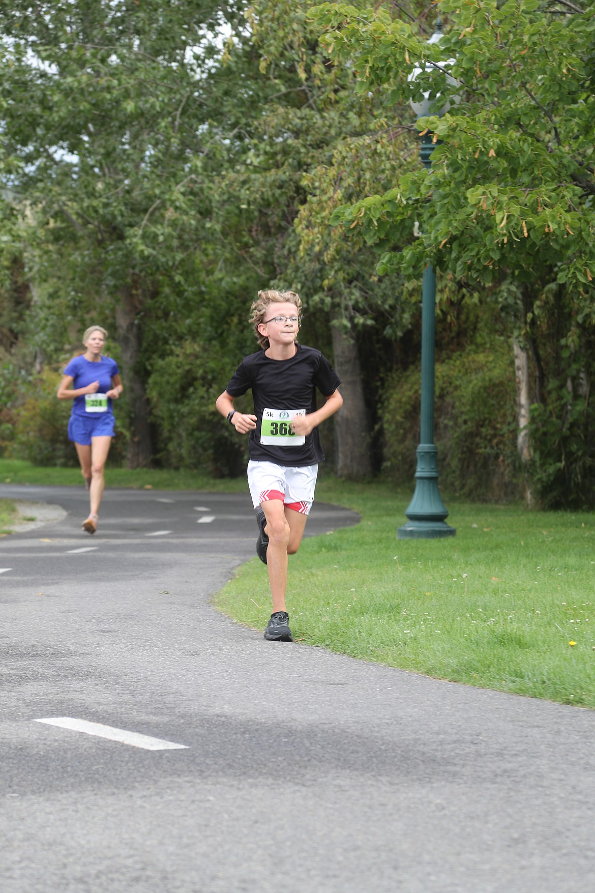 Jude Laughridge races along Sand Creek during the Find Your Strength Family Fun Run on Saturday.