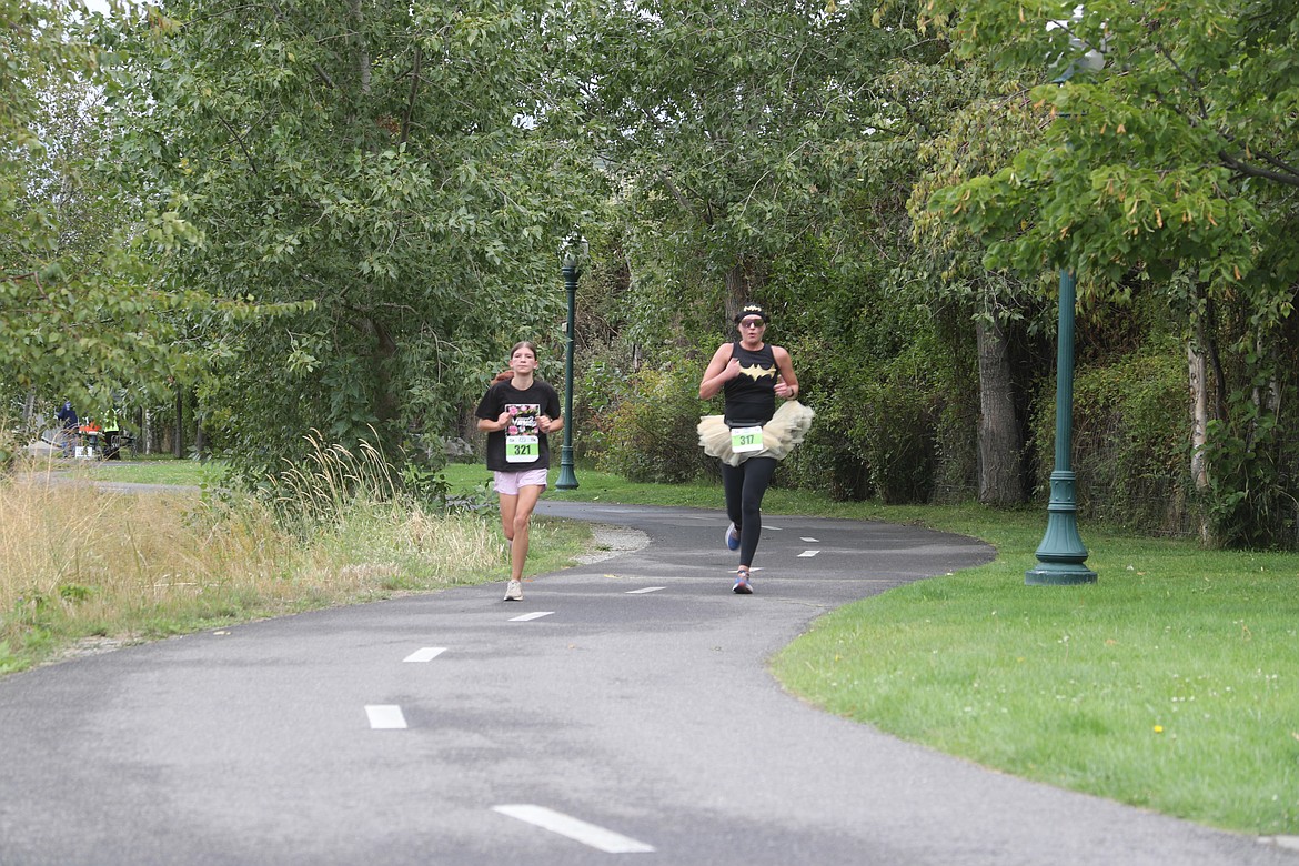 Vivian Schuck, left, and Kendel Roos take part in the  Find Your Strength Family Fun Run on Saturday.