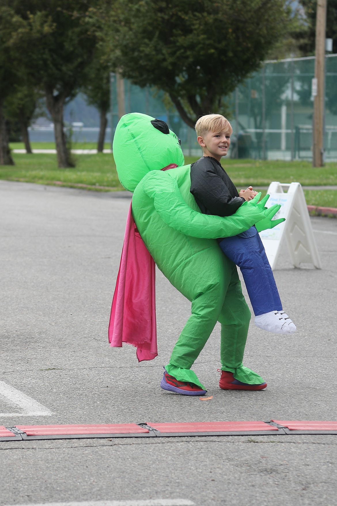 Gavin Schuck, who came dressed as an alien superhero, waits for the start of the 1K race during Saturday's Find Your Strength Family Fun Run.