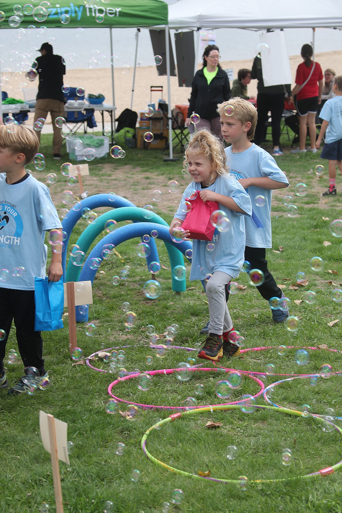 Youngsters are surrounded by bubbles at the Find Your Strength after-party on Saturday, Sept. 14.