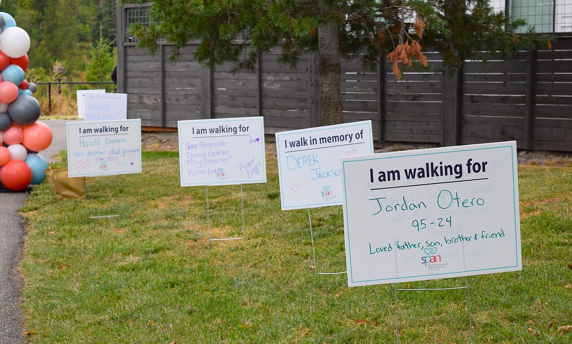 The route for Saturday's annual suicide prevention and awareness walk was lined with signs in honor of those who have been lost to suicide.