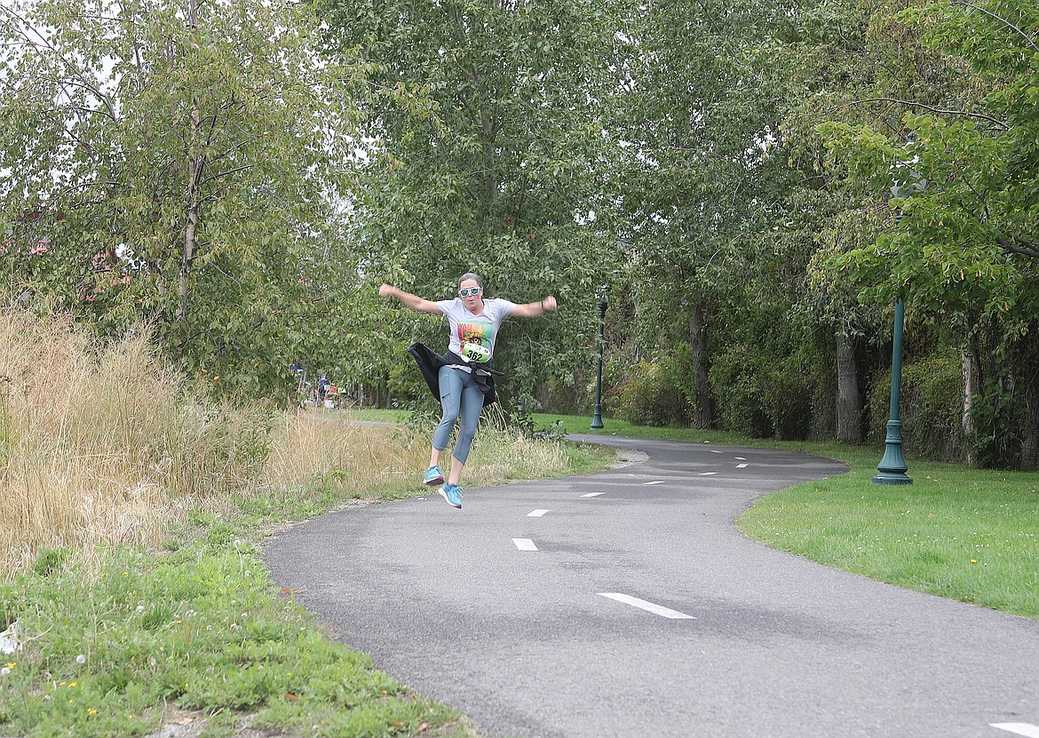 Becky Haag of Sandpoint gives a leap of joy as she takes part in Saturday's Find Your Strength Family Fun Run.