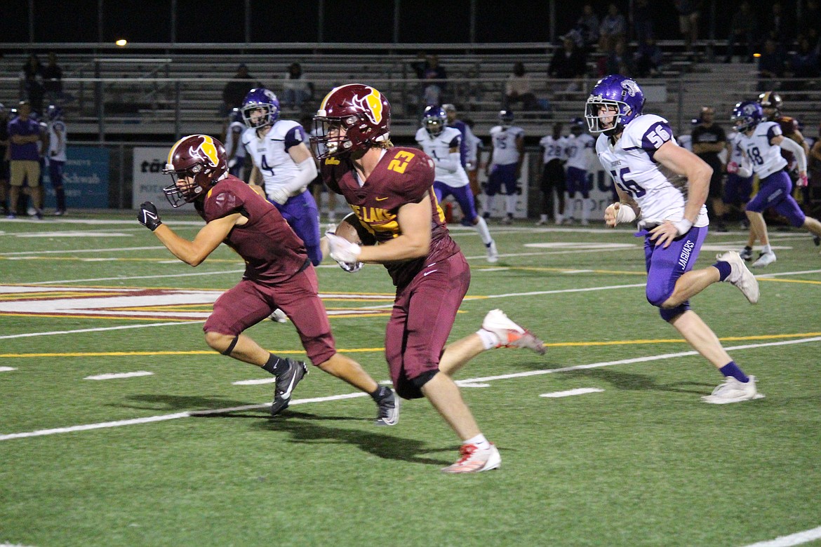 Moses Lake’s Elijah Burns (23) heads upfield during the Mavericks’ 30-23 win over North Creek Friday.