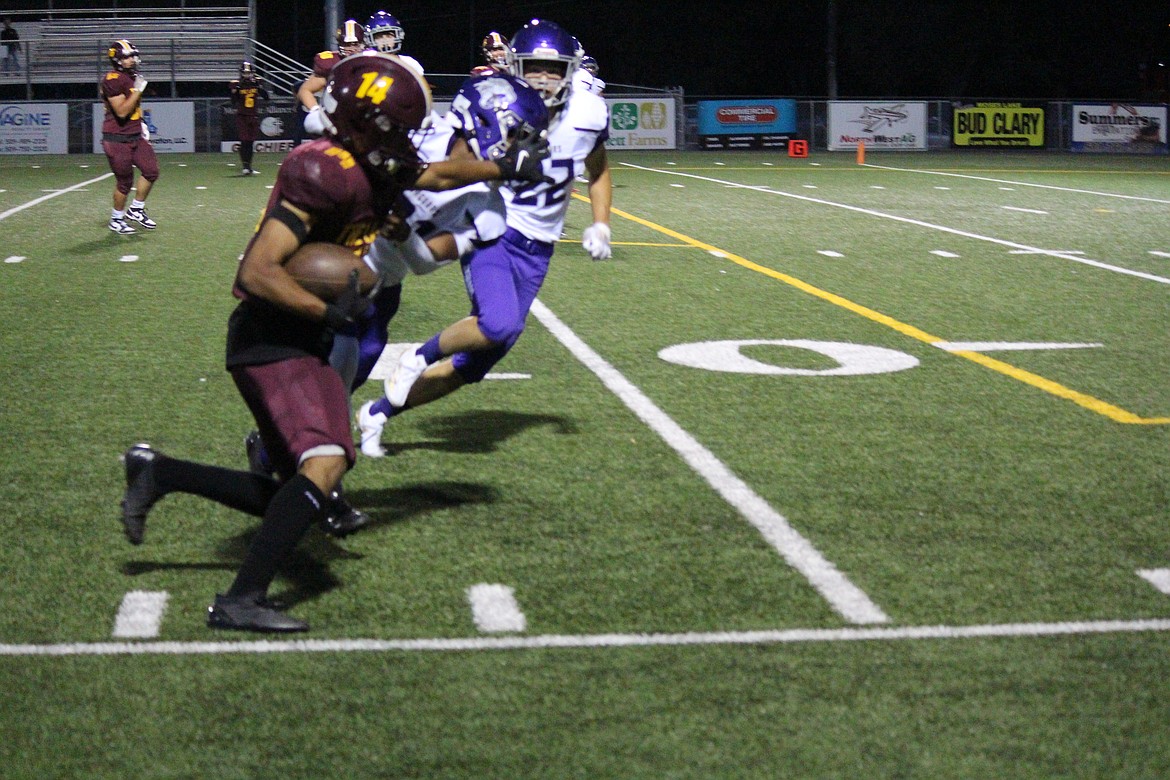 Isiah Moreno-Jackson (14) hugs the sidelines. Moreno-Jackson scored three touchdowns in Moses Lake’s win.