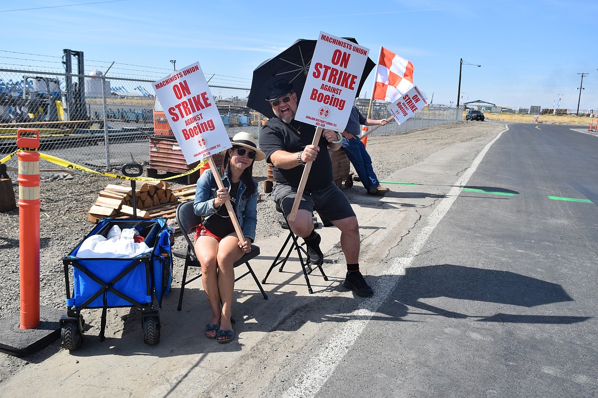 Jeff Groebli and his wife Reagon Groubli strike outside the main gate of Boeing after voting to reject the contract offered to their union.