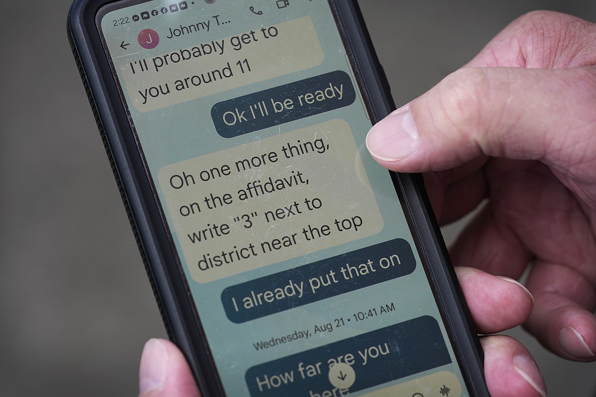 Joseph Wiederien shows a text exchange with a political operative he knew only as "Johnny" as he speaks during an interview with The Associated Press, Friday, Sept. 6, 2024, in Des Moines, Iowa. (AP Photo/Charlie Neibergall)