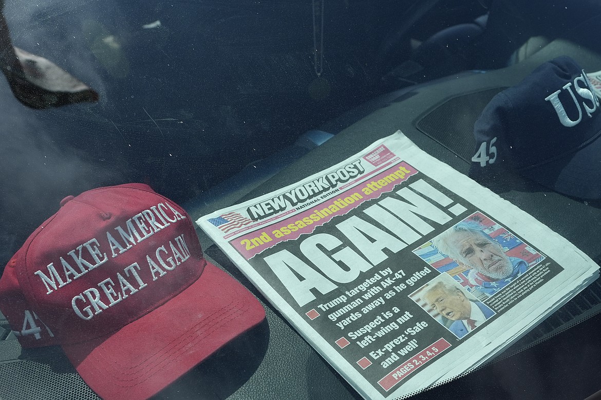 A newspaper is displayed in a vehicle outside of the Mar-a-Lago estate after the apparent assassination attempt of Republican presidential nominee and former President Donald Trump Monday, Sept. 16, 2024, in Palm Beach, Fla. (AP Photo/Lynne Sladky)