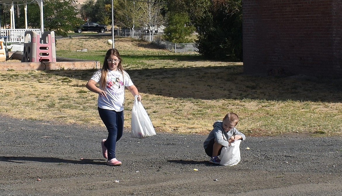 Kimburlee George, 9, and her 4-year-old brother Gavin George dash after candy flung from the Hartline Community Days parade Saturday morning. The George family moved to Hartline about five years ago, father Shonn George said, and couldn’t be happier with their new hometown.