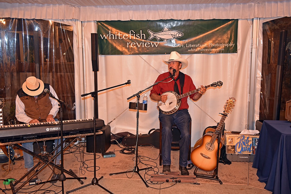 Rob Quist perfomed with Dave Griffith and played a song with the magic Black Ram guitar, pictured on the ground on the right. The guitar was built from a 315-year-old spruce destroyed by a logging road built to the edge of a giant clearcut in Montana’s Yaak Valley. (Kelsey Evans/Whitefish Pilot)