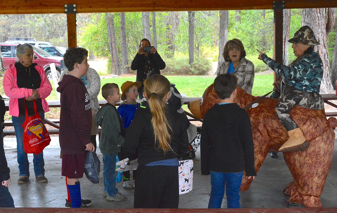 Kelly Morrison, with the St. Regis Senior Center was decked out in her camo hunter blow up bear costume. She led the rock bear hunters in the classic "We're going on a bear hunt" song before the action began on Saturday morning. (Mineral Independent Amy Quinlivan)