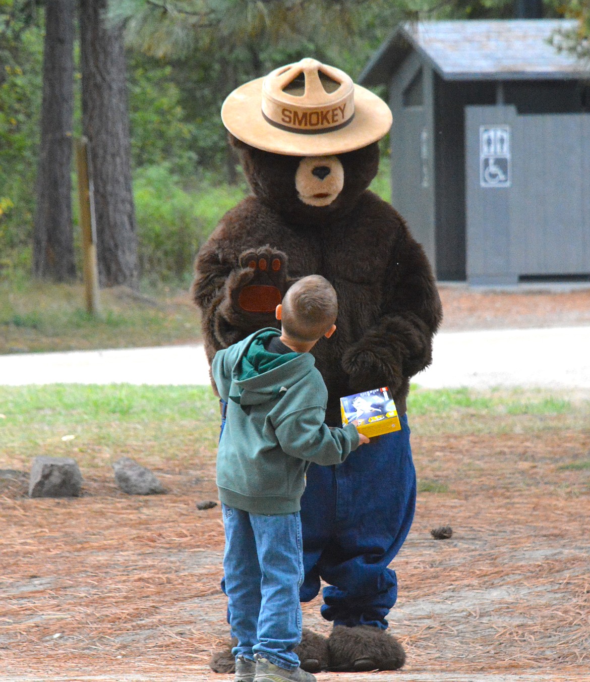 Even Smokey the Bear from the Superior Forest Service office came by for a special visit. Following the scavenger hunt hungry bear hunters ate hot dogs and drank warm refreshments provided by the St. Regis Senior Center as they looked through their rock collections they had found. This bear hunter wanted to show Smokey his lego set he won as a prize.  (Mineral Independent/Amy Quinlivan)