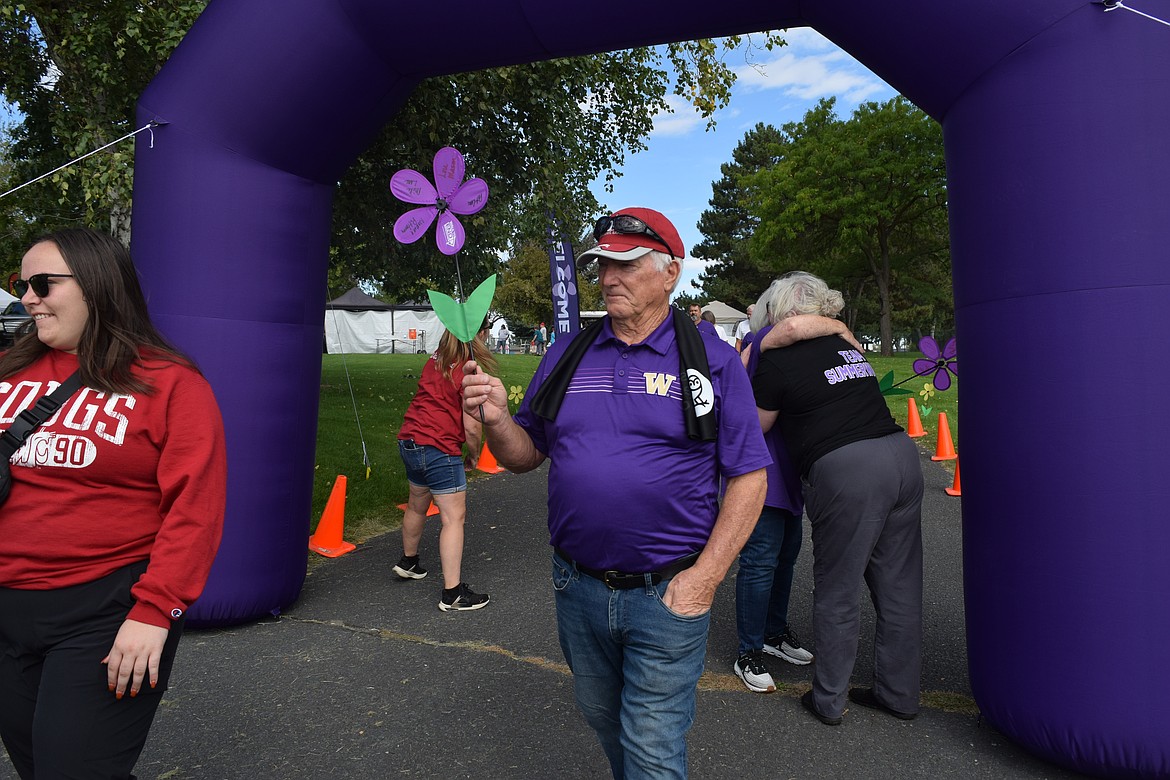 Jon Lane, a participant of the Walk to end Alzheimer's finishes the walk on Sat. Lane was walking for his mother, brother, sister-in-law and his “best friend in the whole world.”