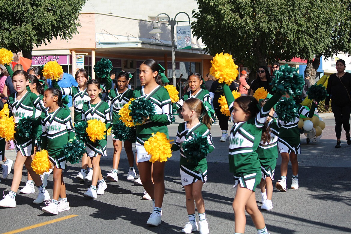 Quincy junior cheerleaders back the Jacks with a cheer while walking in the FCAD parade.