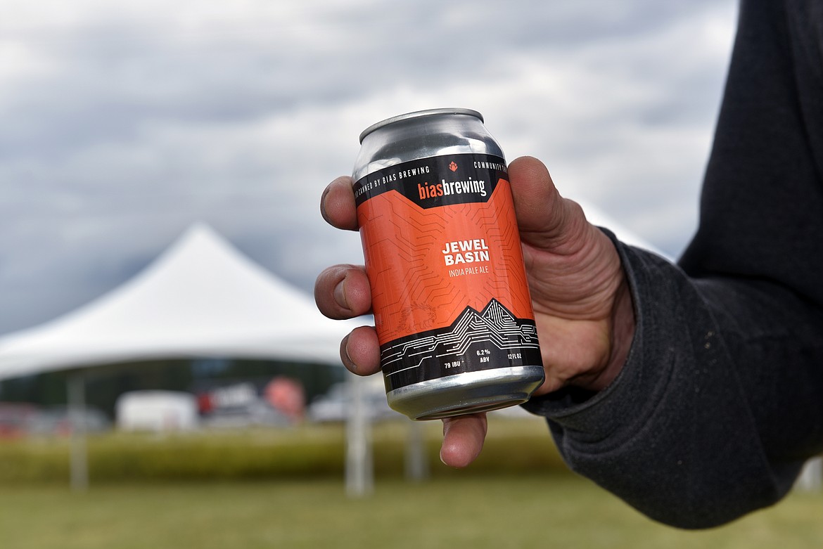 J.D. Dohtry, brewer at Bias Brewing, holds up a crisp Jewel Basin IPA at the Whitefish Food and Wine Festival tasting session Saturday. (Kelsey Evans/Whitefish Pilot)