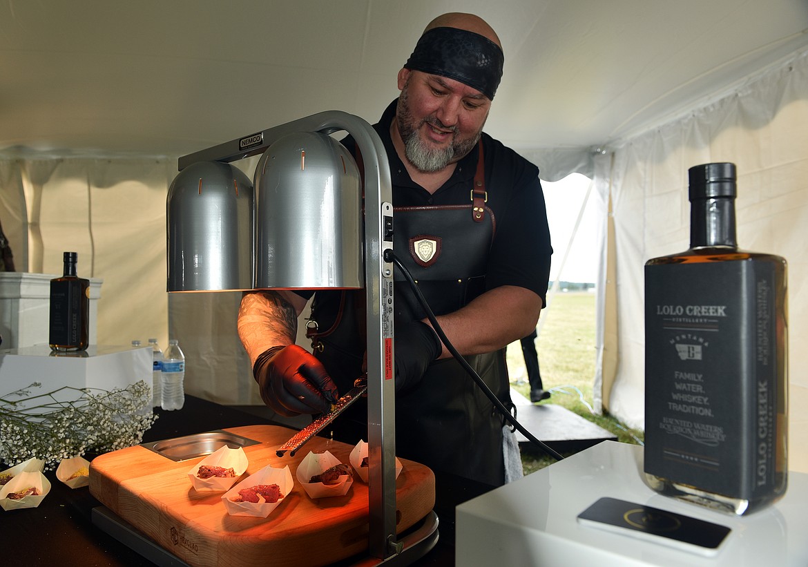 Chef Michael Tolomeo prepares bison at the Whitefish Food and Wine Festival tasting session. (Kelsey Evans/Whitefish Pilot)