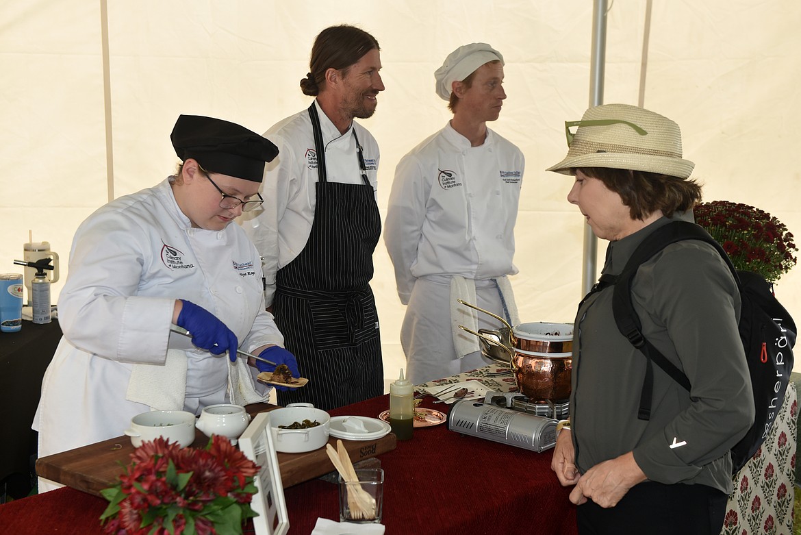 Maya Roger, student at Flathead Valley Community College Culinary Institute, serves duck rillette at the Whitefish Food and Wine Festival tasting session. On the right is Andy Blanton and Josh Rutherford. (Kelsey Evans/Whitefish Pilot)