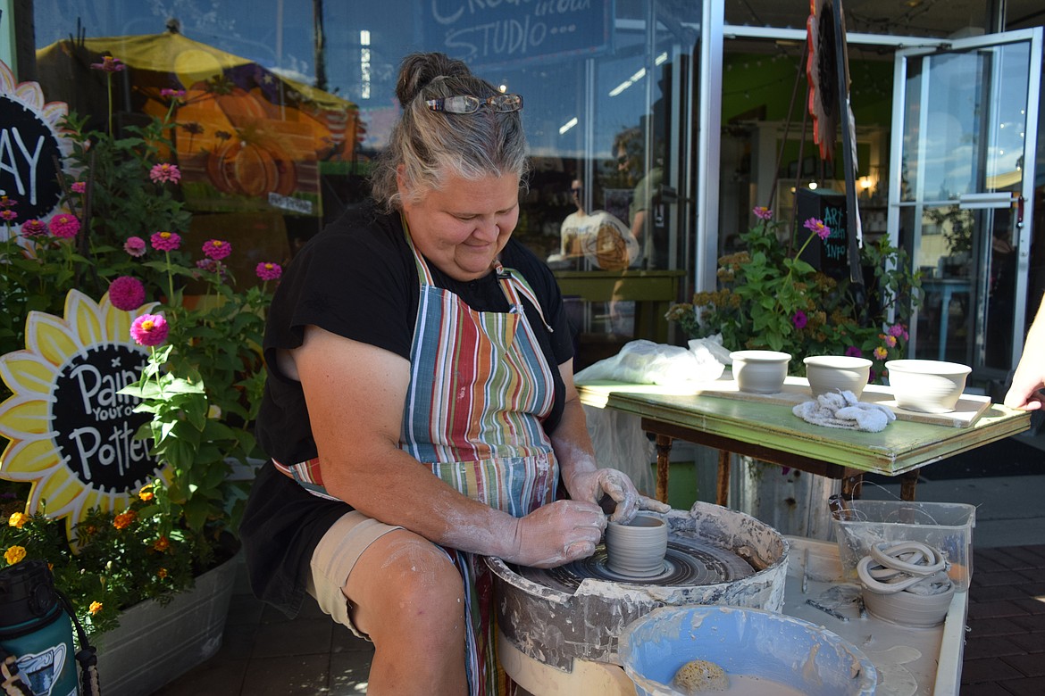 Laura Mayer, owner of Artgarden, was teaching people how to use a wheel and throw clay.