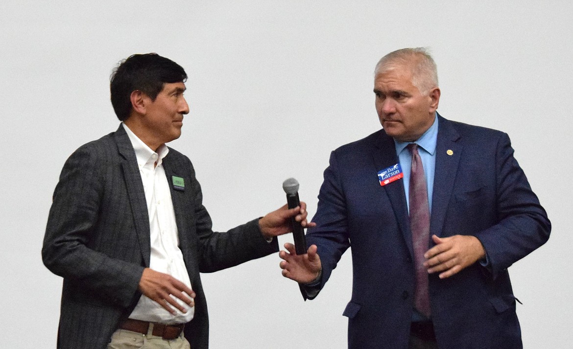 Sal Mungia hands the microphone to Dave Larson during the forum at Wahluke High School Sept. 12. The two are running for the Washington State Supreme Court.