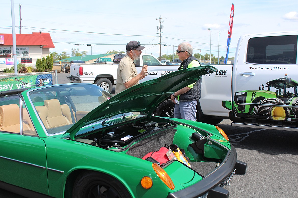 John Hill, left, talks to a spectator about his Porche, which commemorated a milestone for his late mom.