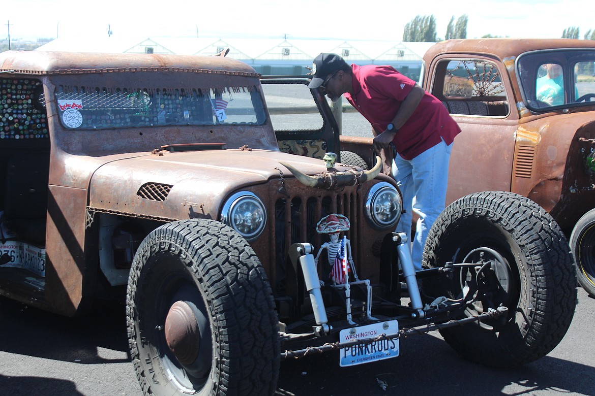 A spectator takes a close look at a rat rod at the Brett Reese Memorial car show in June.