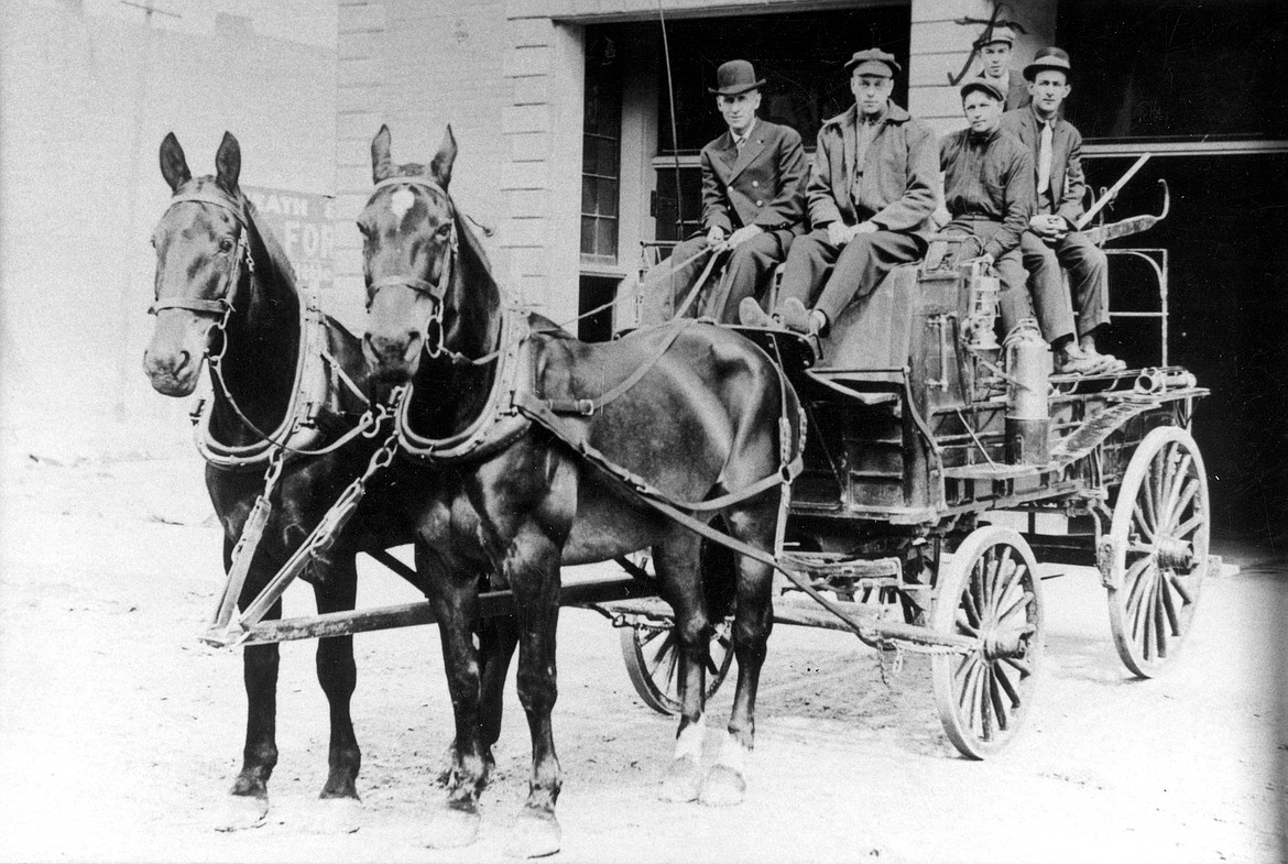 Early Sandpoint firefighters are pictured aboard a horse-drawn fire engine in front of the old Sandpoint Fire Station, located in what is now the Music Conservatory of Sandpoint.