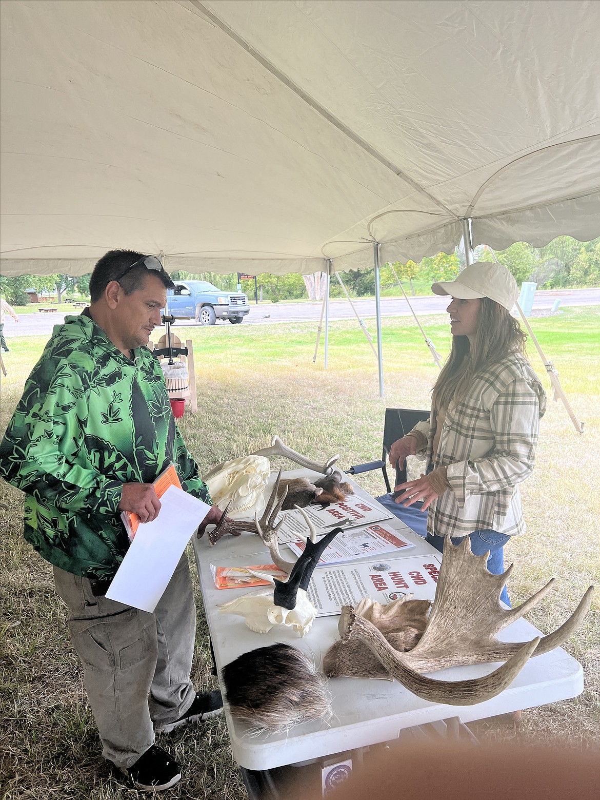 Patrick Hammer, left, and Shaylie Durglo, CSKT Wildlife Biologist, discuss some liver flukes found on Hammer's deer's liver last year, (Berl Tiskus/Leader)