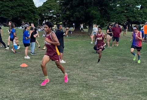 Moses Lake sophomore Duane Zamora, left in maroon, and senior Angel Verduzco, right in maroon, compete at Saturday’s Iolani Cross Country Invitational in Hawaii.